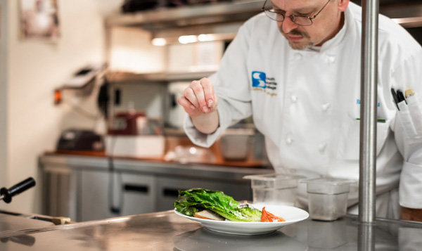 South Seattle College Culinary student preparing a salad plate