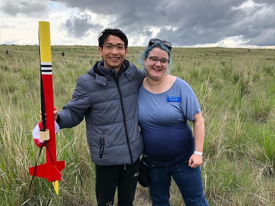 Rocket Club mentor and student at a launch 