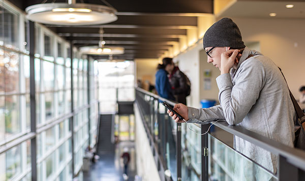 South Seattle student in hallway working on their phone