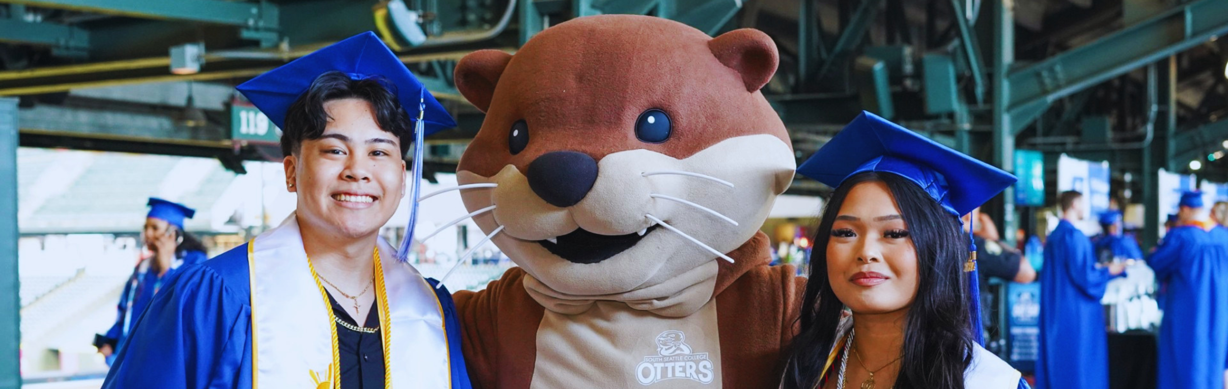  Graduates posing with South Seattle's mascot, Olivia Otter 
