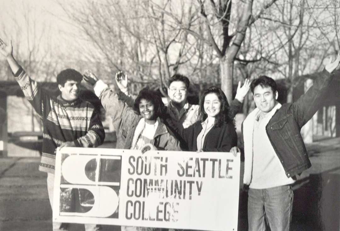 Students holding a South Seattle Community College sign in the 1990s, before the college dropped "Community" from it's name.