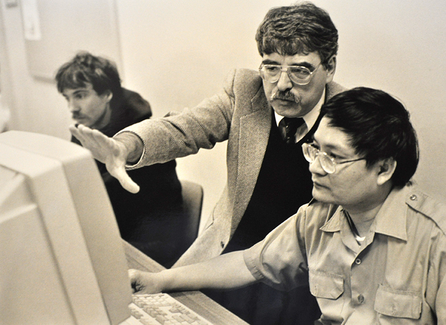 Instructor and student working on a Hewlett-Packard 150 computer. 